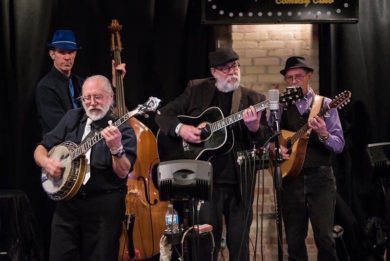 Band playing guitars and other stringed instruments